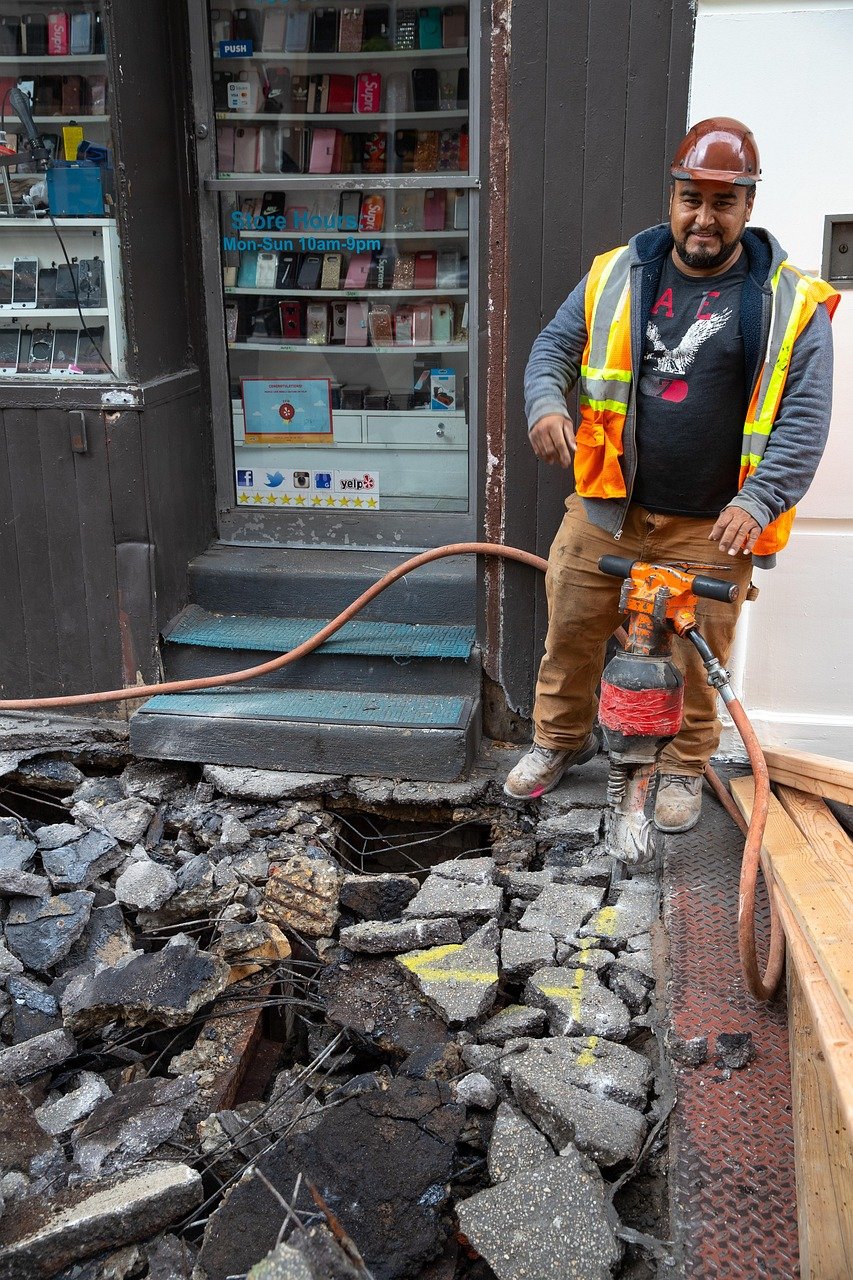 Contractor using a pneumatic breaker with an air hose